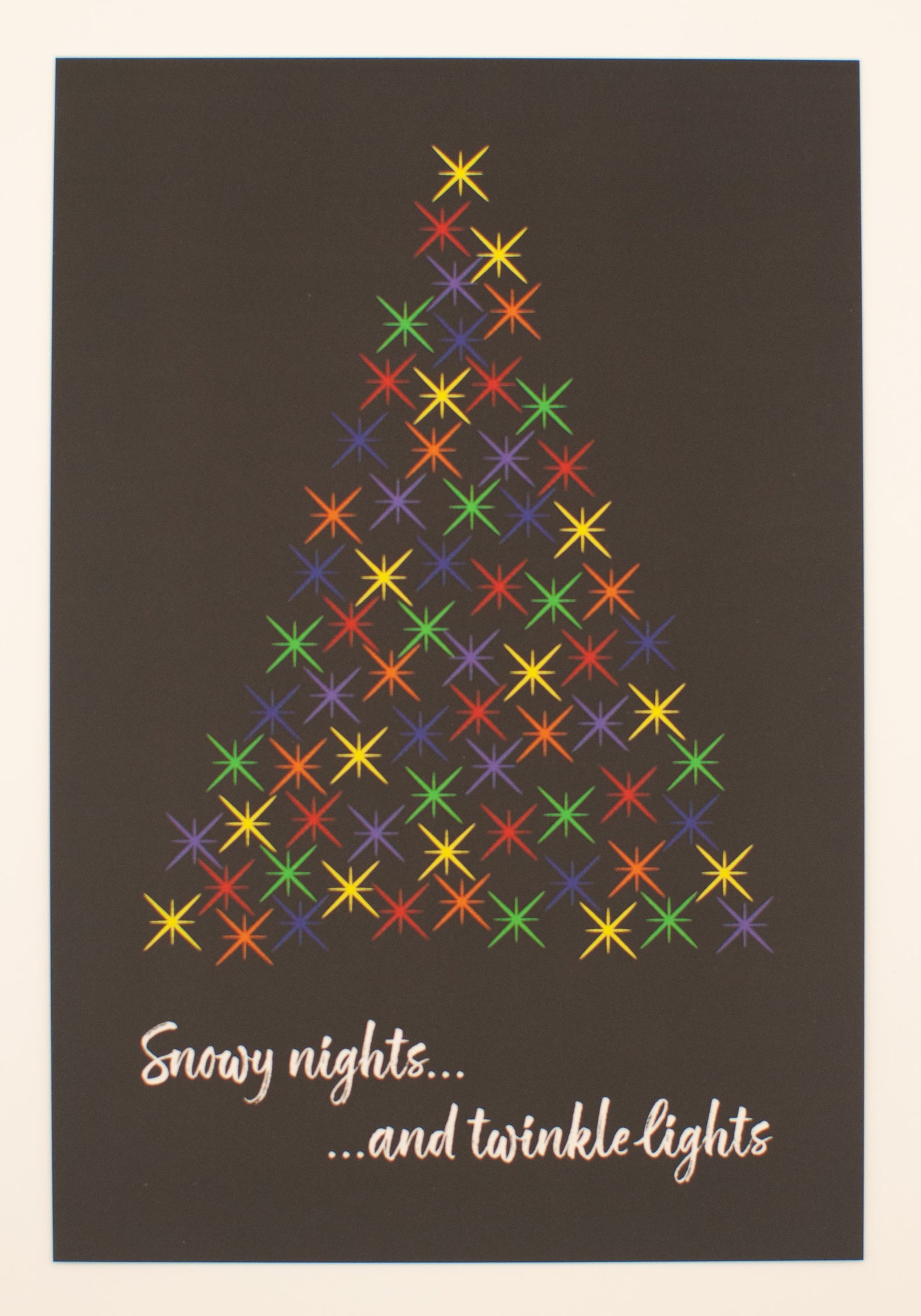 Colorful star pattern forming a Christmas tree on a dark background with text 'Snowy nights... and twinkle lights'.