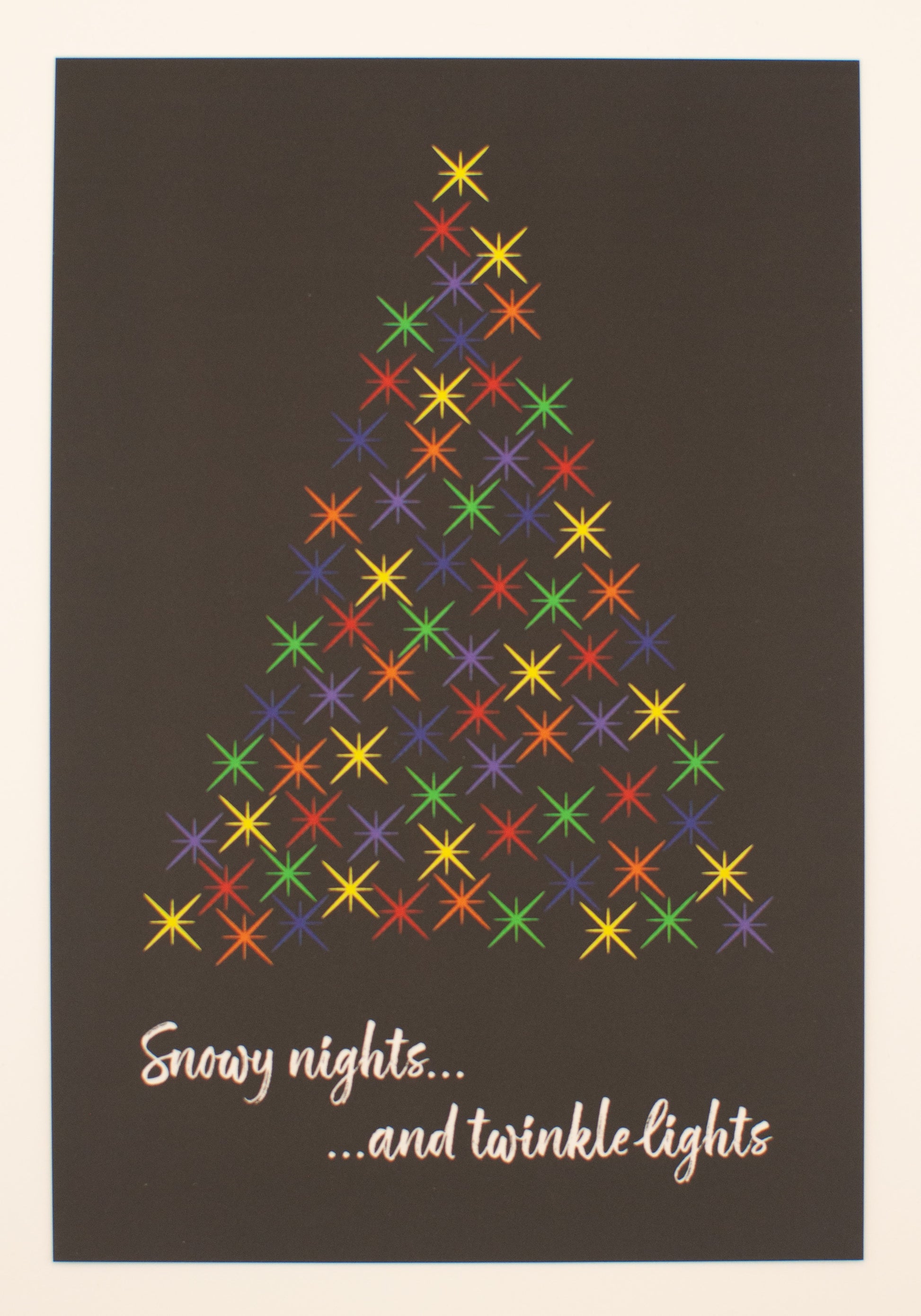 Colorful star pattern forming a Christmas tree on a dark background with text 'Snowy nights... and twinkle lights'.