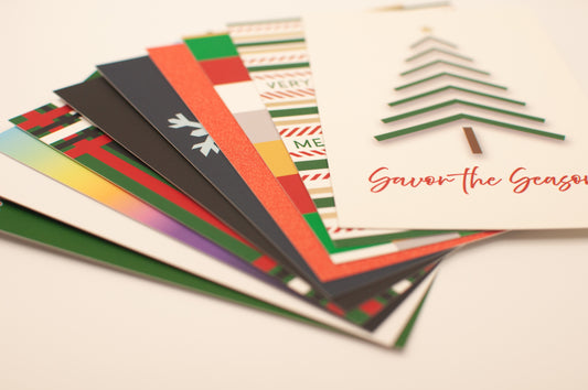 Stack of Christmas-themed greeting cards on a light background