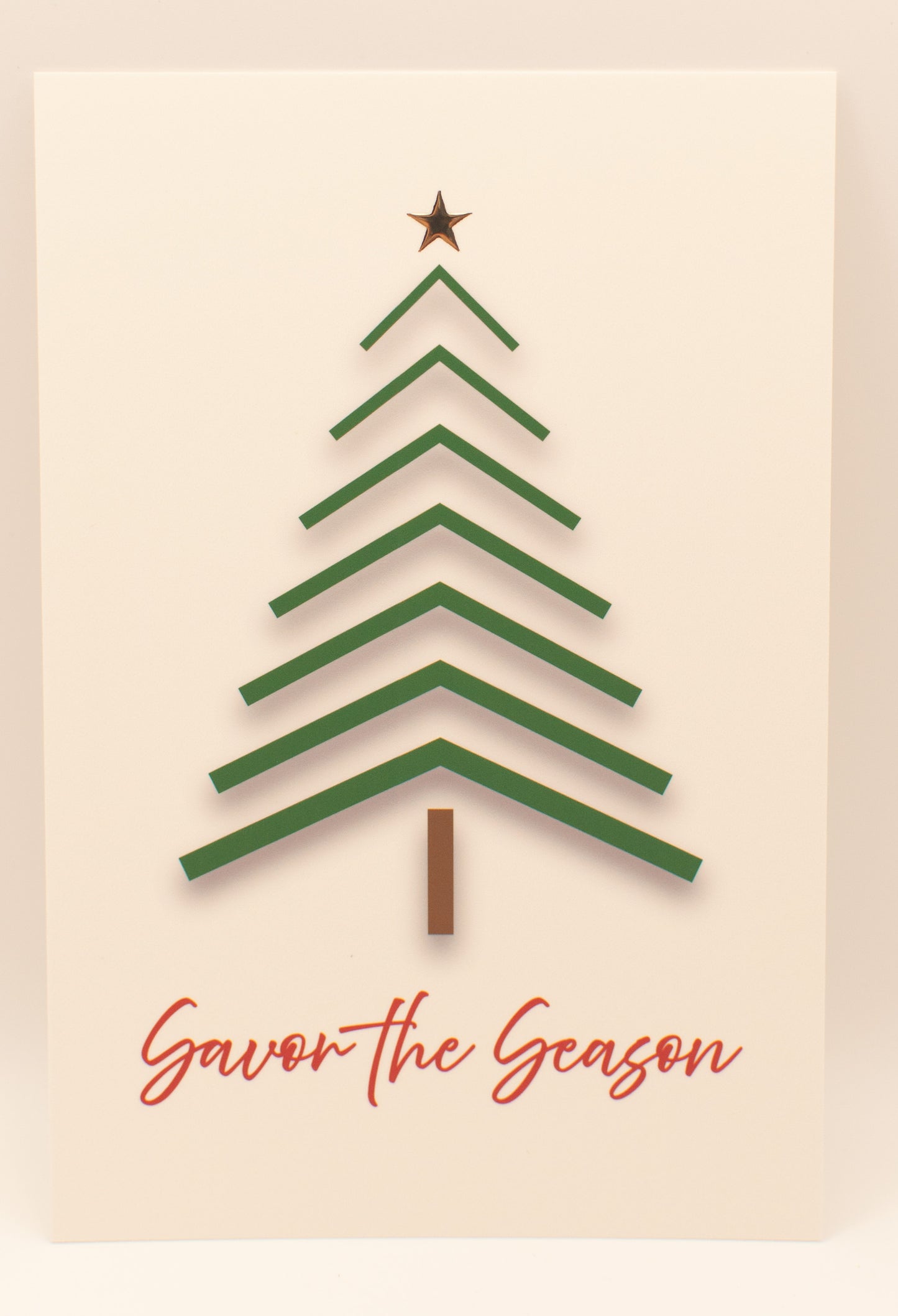 Green Christmas tree with a star on top and 'Savor the Season' text on a beige background