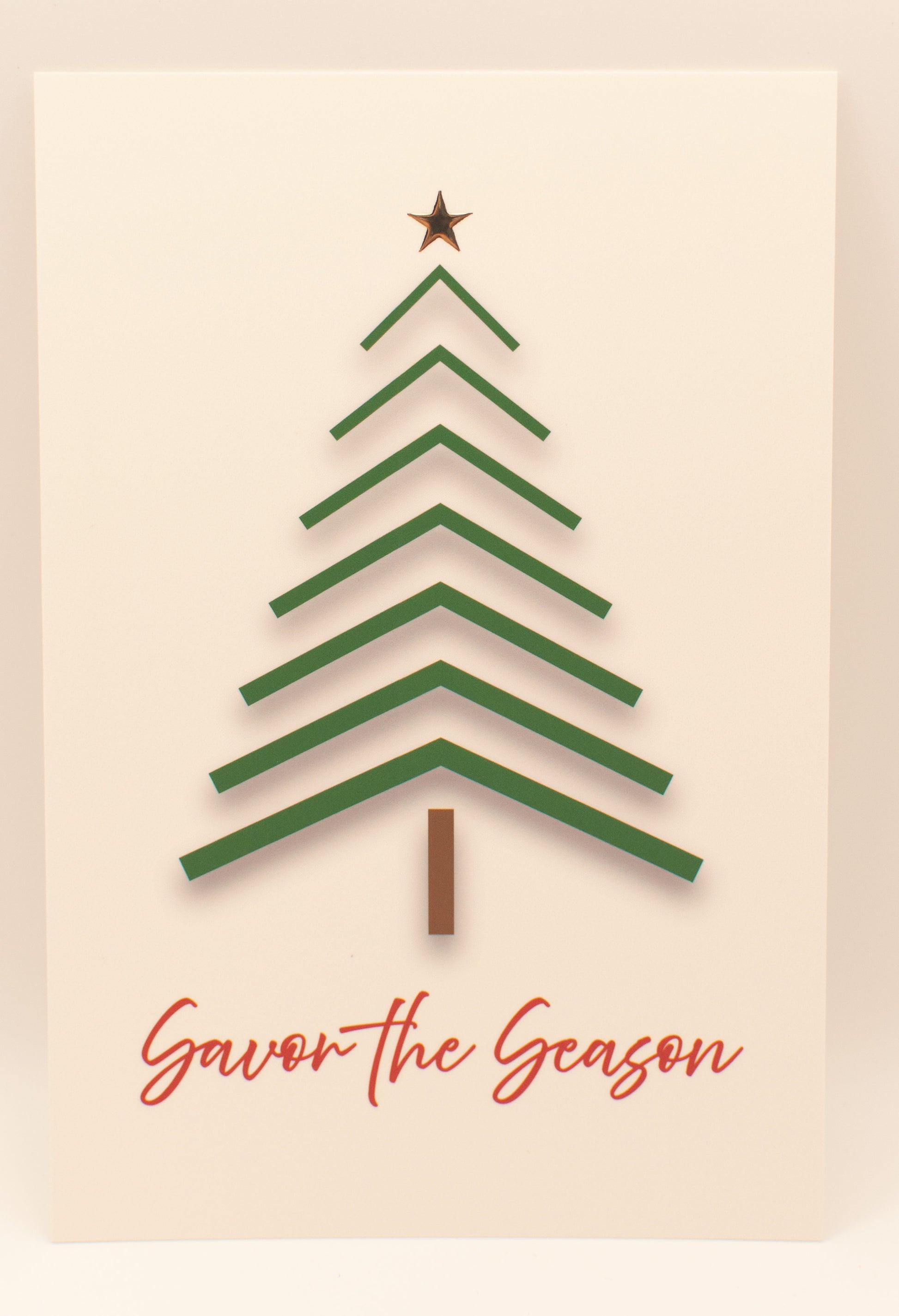 Green Christmas tree with a star on top and 'Savor the Season' text on a beige background