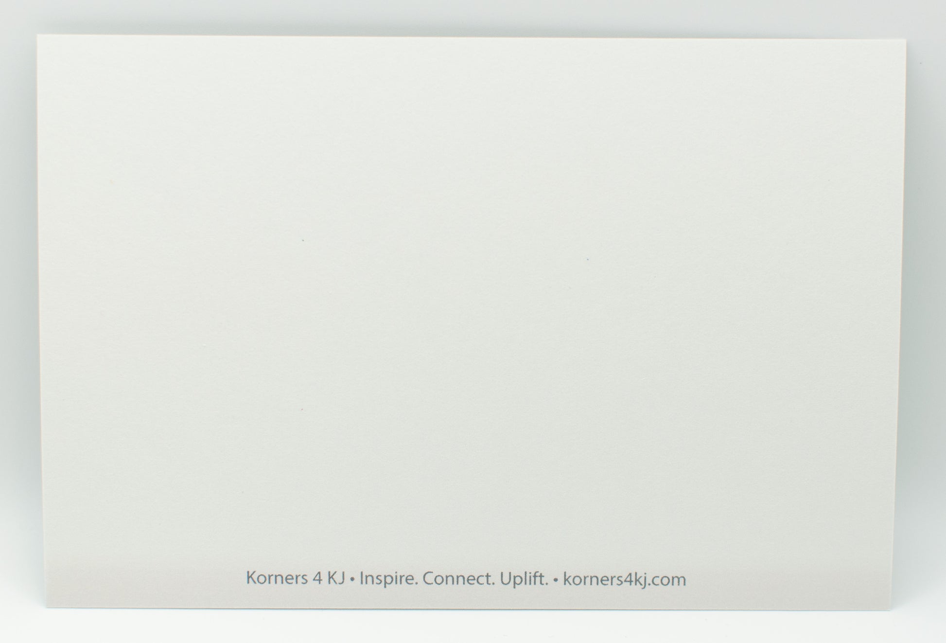 White card with text 'Korners 4 KJ' and website URL on a white background